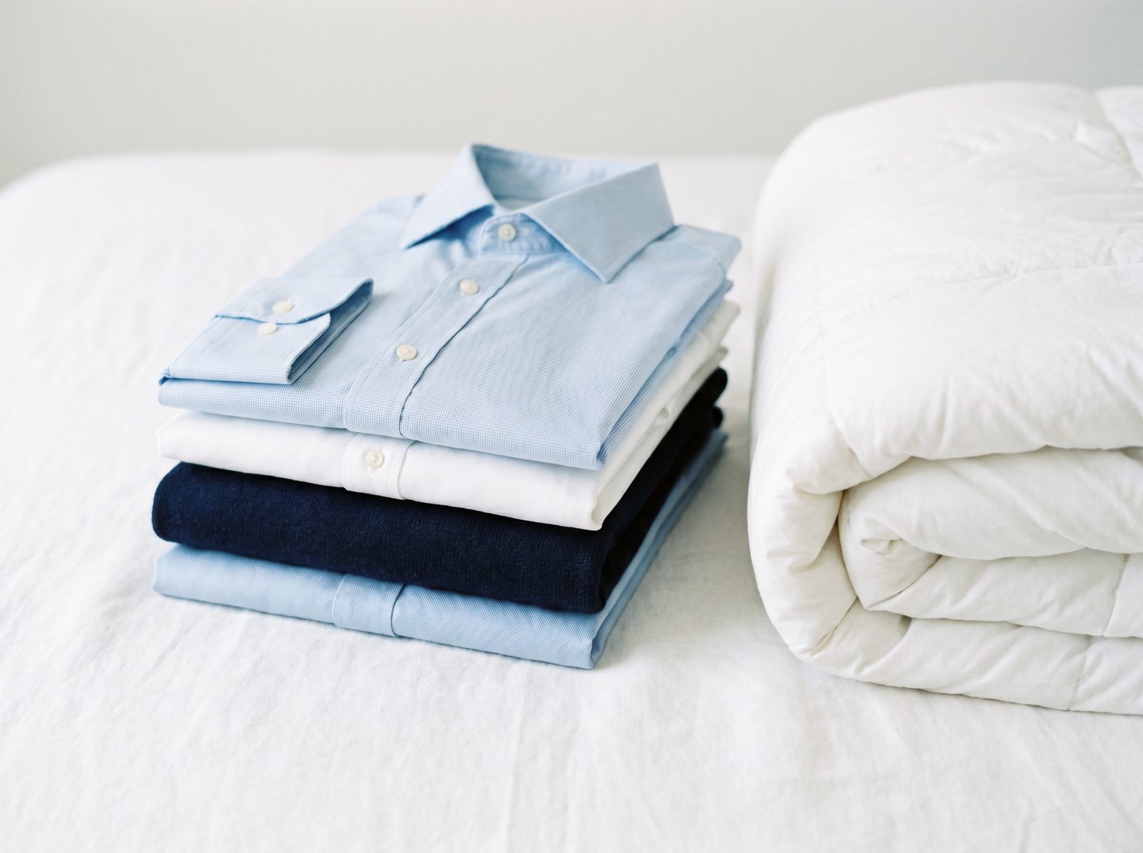 Neatly folded shirts and a fresh comforter, ready for delivery